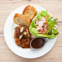 Wall Mural - Pork sirloin steak with gravy sauce, salad and garlic bread