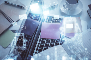 Poster - Envelop hologram drawing over computer on the desktop background. Top view. Double exposure. Technology concept.