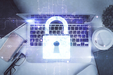 Poster - Double exposure of lock hologram drawing over study table background with computer. Concept of data security. Top view.