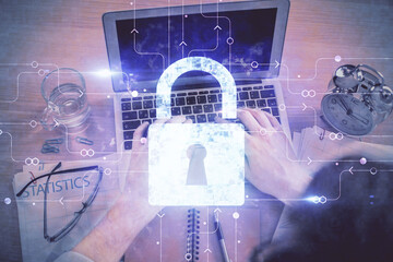 Poster - Multi exposure of man's hands typing over computer keyboard and lock hologram drawing. Top view. Technology concept.