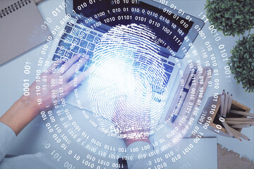 Poster - Double exposure of woman hands working on computer and fingerprint hologram drawing. Top View. Digital Security concept.