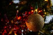 Closeup shot of a golden color Christmas ornament on a tree