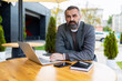 © Ivan Traimak - adult male businessman with beard working on laptop outside