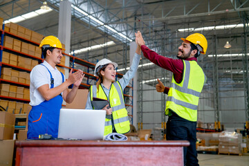 Warehouse manager woman clap hands with her co-worker to express successful of the project and also cheer up by clapping hands by the member in workplace.