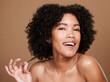 © J Maas/peopleimages.com - Black woman, natural and curly hair wellness model for luxury cosmetics product mockup on brown wall of studio background. Happy African girl, healthy skincare beauty and afro for salon spa treatment