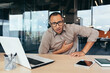 © Liubomir - heart attack at work, businessman sick has severe chest pain heartache, african american man working inside office building using laptop.