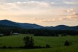 Scenic shot of grass fields and mountain silhouettes in Madison County, Virginia, USA during dusk