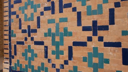 Wall Mural - Tourist historical center of Bukhara. Close-up. Historical mosaic on the walls of an ancient madrasah in a Muslim country.