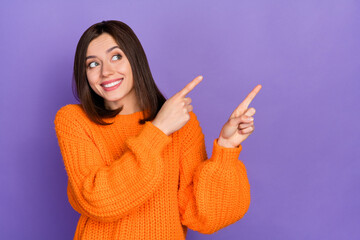 Wall Mural - photo of charming cheerful girl look indicate fingers empty space news isolated on violet color back