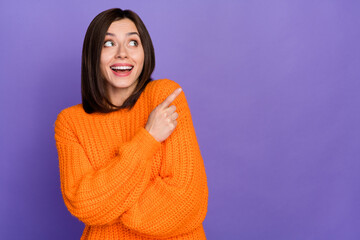 Wall Mural - Portrait of positive charming girl look direct finger empty space promotion isolated on purple color background