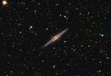NGC 891 Galaxy In The Andromeda Constellation, And Some Stars In The Background.