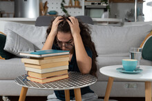 Young Schoolgirl Or University Student Has A Headache When She Sees How Much She Has To Study In Order To Prepare For The Exam And Achieve Knowledge After Illness And Absence From Classes And Lectures