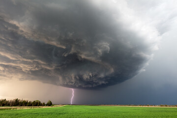 Wall Mural - storm clouds over a field