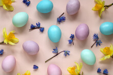 Colorful Easter Eggs And Spring Flowers On Pink Background, Top View.