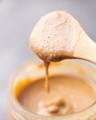 Closeup of peanut butter on wooden spoon
