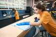 Cleaners in a coworking area cleaning and disinfecting work surfaces