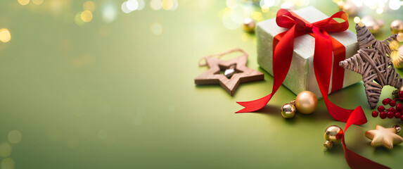 Wall Mural - christmas greeting card or christmas banner design - gift box and ornaments on light green backgroun