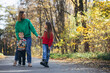 © Petro - Mother with children walking in park