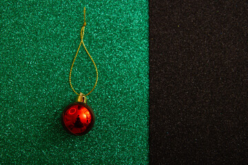 Wall Mural - red christmas ball on green background