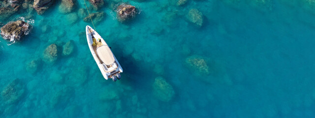 Wall Mural - Aerial drone top down photo of inflatable speed boat anchored in tropical exotic island