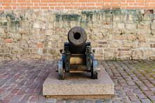 Old Canon Outside Of The Old City Wall Of Riga, The Capital City Of Latvia