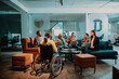 © .shock - Businesswoman in wheelchair having business meeting with team at modern office. A group of young freelancers agree on new online business projects