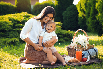 Poster - Mother with her baby daughter having picnic in garden on sunny day