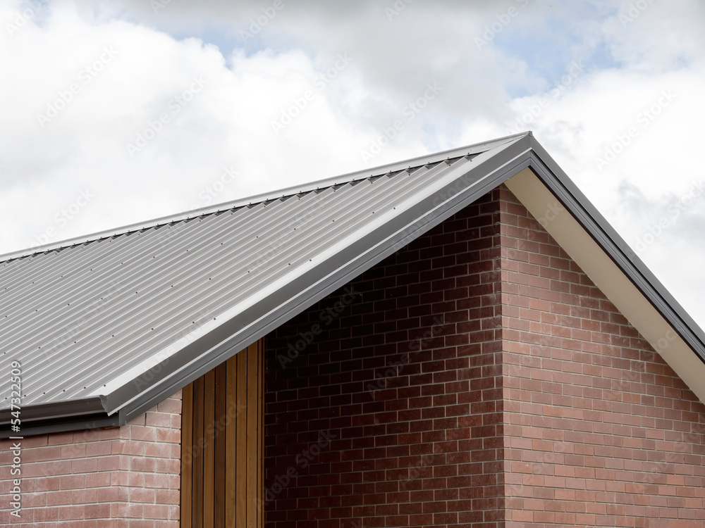 Gable roof on red brick house with sheltered patio space Stock Photo ...