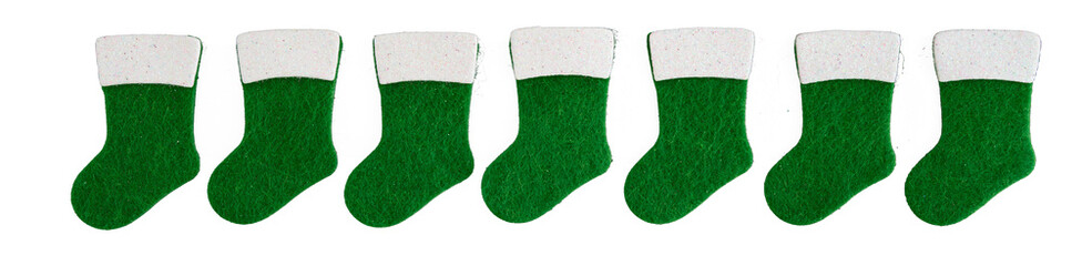 Row of small traditional green and white felt Christmas stockings, celebrating winter holidays
