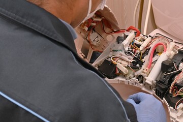 Wall Mural - Flush toilet ( Electric bidet seat ) Repair work scene. Technicians are replacing parts to fix the problem.