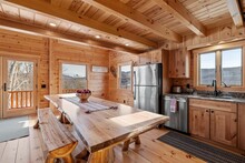 Kitchen And Living Room Interior Of Log Cabin In Mountains