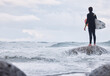 © D Theron/peopleimages.com - Sports, ocean surfing and man ready for fitness challenge, nature practice training or waves travel in sea water mock up. Sky storm clouds, adventure and mockup back view of surfer with freedom peace