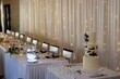 Wedding table setting in cream tones and a festive cake with black strokes of paint