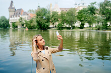 Tourism And Technology. Traveling Young Woman Taking Selfie Near Castle In Budapest, Hungary.