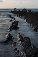 Wall Mural - Beautiful sunset landscape image of Welcome Mouth Beach in Devon England with beautiful rock formations