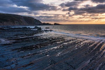 Wall Mural - Gorgeous vibrant aerial drone landscape sunset image of Welcombe Mouth Beach in Devon England