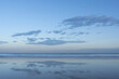 Sky with clouds reflected on beach and sea with copy space, wallpaper use.
