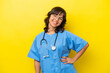 © luismolinero - Young nurse doctor woman isolated on yellow background