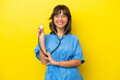 © luismolinero - Young nurse doctor woman isolated on yellow background