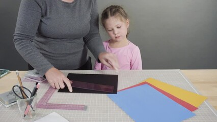 Wall Mural - Little girl making a handmade Father's Day card from construction paper.