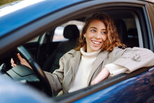 Young Woman Driving A Car In The City. Car Sharing, Rental Service Or Taxi App.