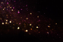 Background Of Abstract Glitter Lights. Gold And Black. De Focused