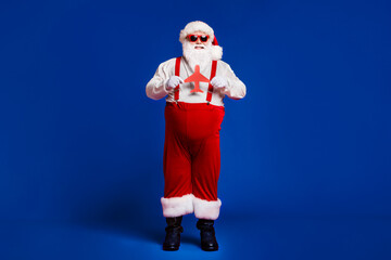 Poster - Full length body size view of his he attractive cheerful cheery glad fat Santa holding in hands paper plane figure isolated bright vivid shine vibrant red burgundy maroon color background