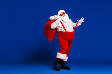 Poster - Full length body size view of his he attractive childish cheerful cheery funny fat Santa carrying big large sack having fun dancing isolated bright vivid shine vibrant red color background