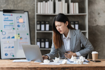 Wall Mural - Stressed Asian business woman worry about marketing plan of this years. Account, Real Estate Agent, Finance concpet