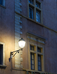 Wall Mural - Ancient windows illuminated by street light in old district of Lyon, France