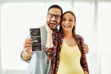 woman pregnant couple man pregnancy family mother love father happy husband baby wife belly expecting bonding happiness maternity parent ultrasound scan picture photo