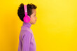 Profile photo of positive person look empty space listen new playlist isolated on yellow color background