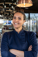 young north african chef woman smiling on camera at the restaurant - focus on face