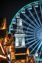 Illuminated Blue Ferris Wheel And Bell Tower On Festive Kontraktova Ploshcha (Square Of Contracts) In Kyiv, Ukraine Decorated For Christmas Holidays At Night. Celebrating New Year In The City